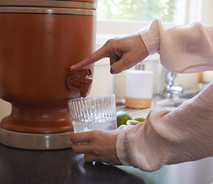 Person pouring water from water filter