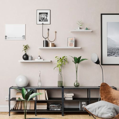 Floating  wall shelves with wall prints, ornaments, and various vases on a book shelf