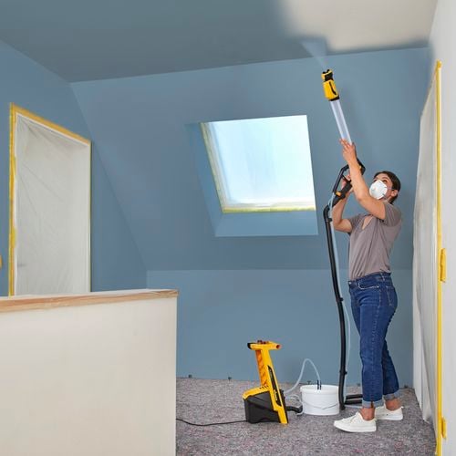 Wagner
  Flexio W950 using spray lance with i-Spray nozzle to spray tall ceilings
  inside a home
