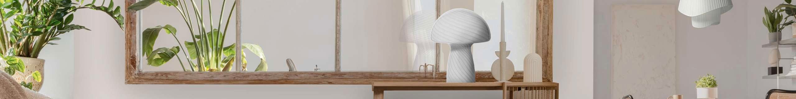 Stylish lamp on table and pendant on top of a dining setting.