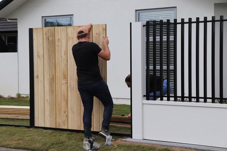 Person installing timber fence