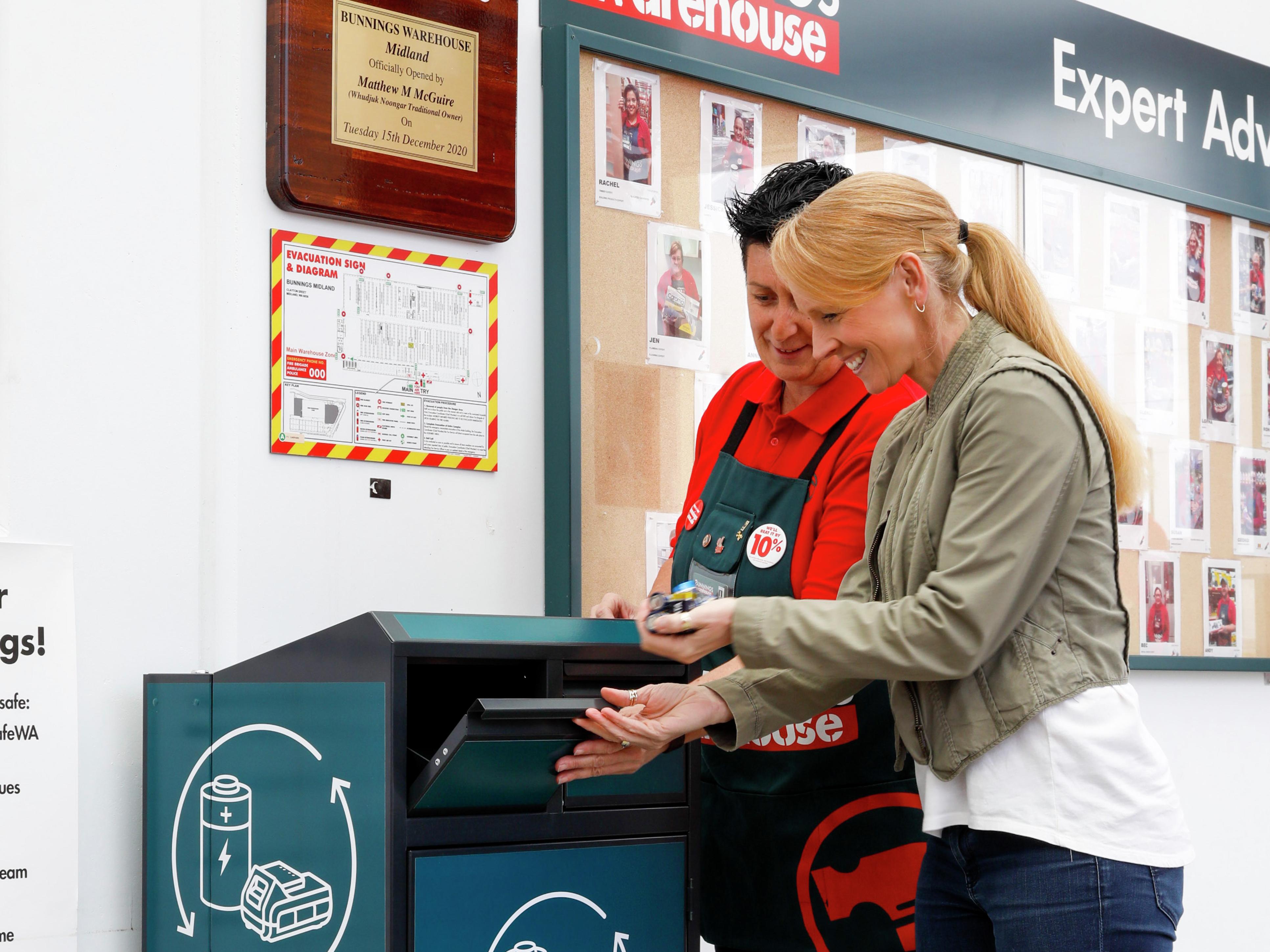Bunnings team member helping a customer recycle her battery.