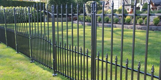 Sheffield designer no dig fencing in a front yard on lawn.