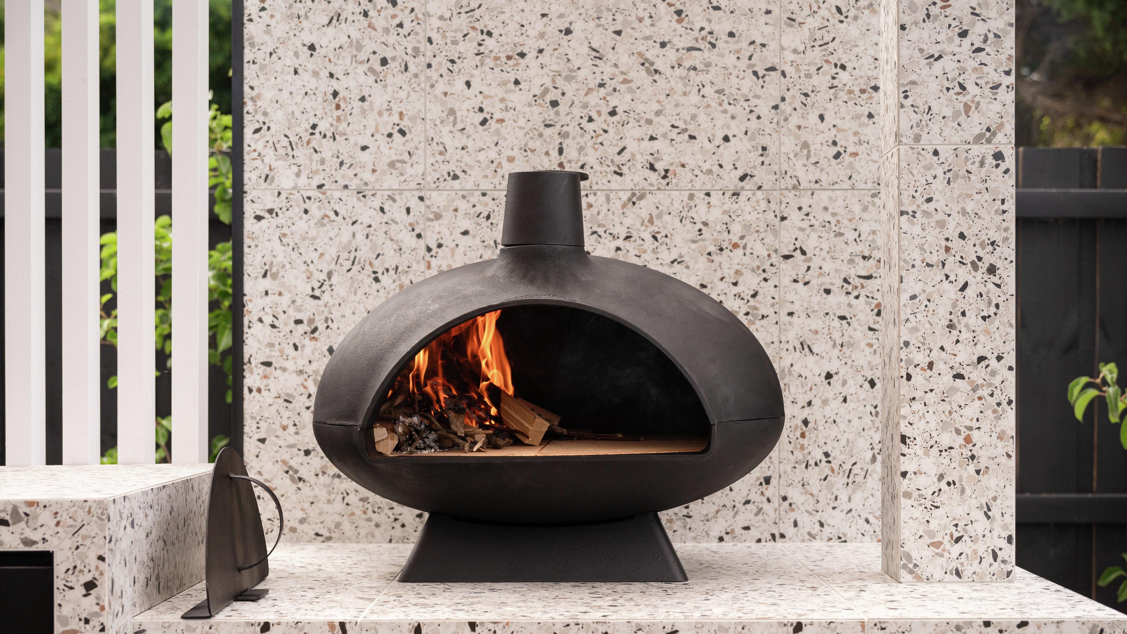Close up of an outdoor Chapala black cast iron pizza oven.
