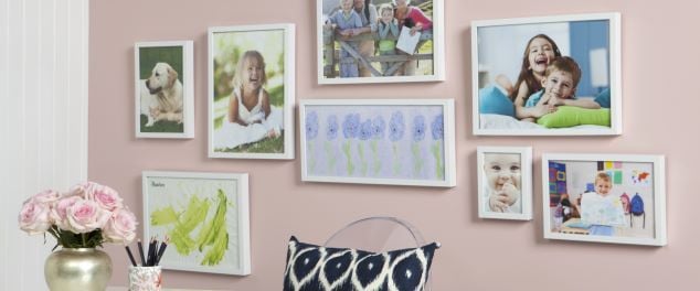Framed family pictures hung on a wall
