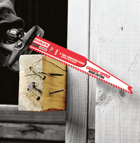Person using jigsaw to cut through timber beam