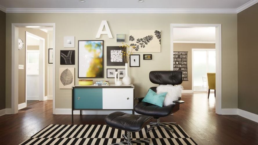 Pictures hung on wall using adhesive hooks and strips