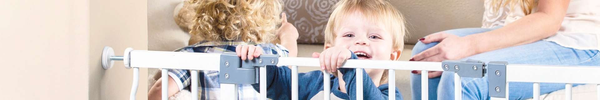 Toddler peaking over child safety gate