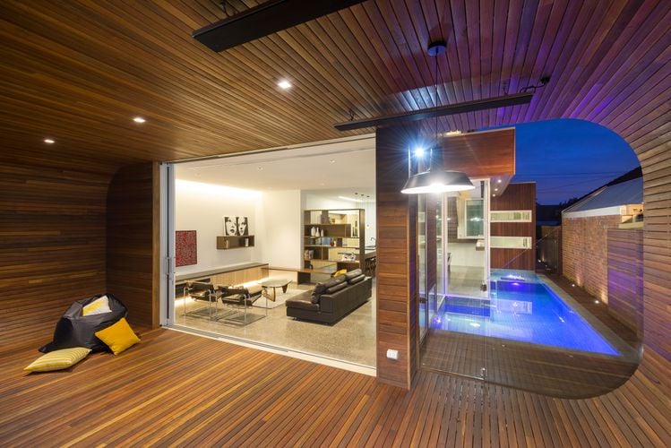 Outdoor timber decking next to pool and dining room
