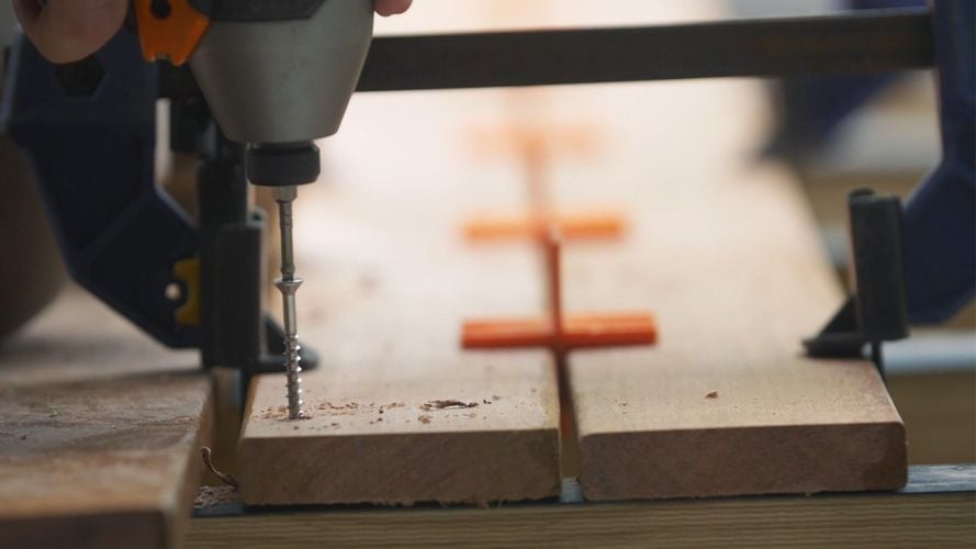 Screw being drilled into timber