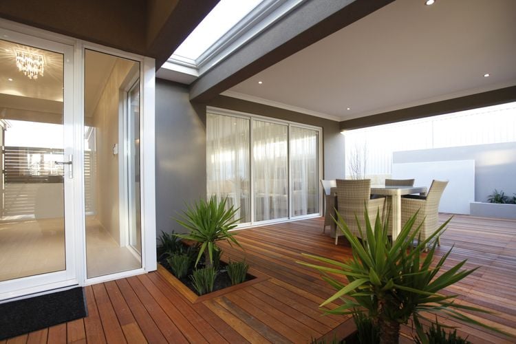 Outdoor timber decking dining space with dining table and chairs