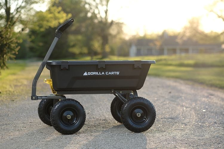 Empty Gorilla Carts cart sitting on gravel driveway