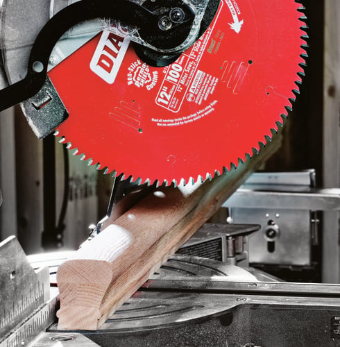 Circular saw cutting through wooden bannister