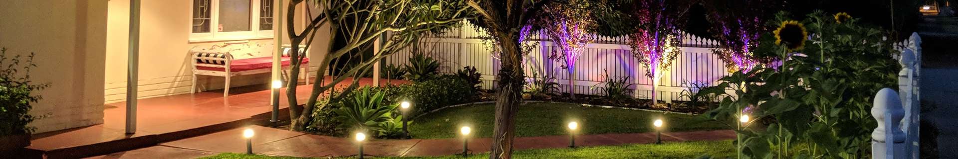 A front garden with a verandah and lighting.