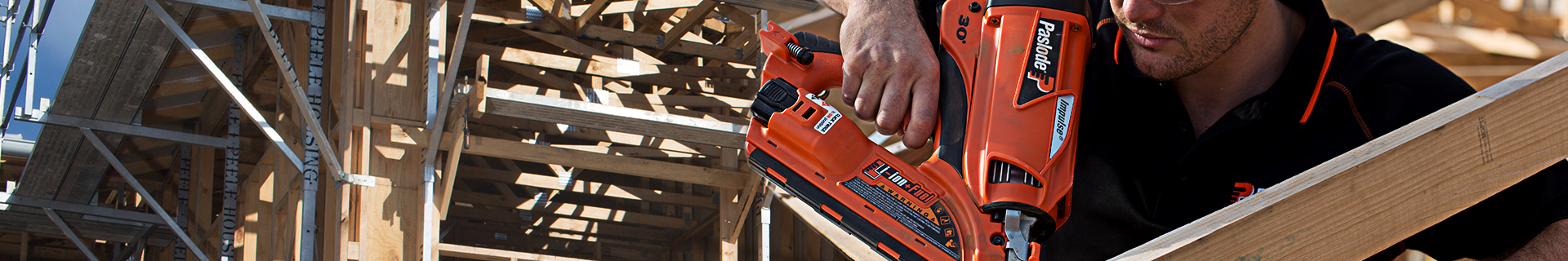 Man using Paslode nail gun.