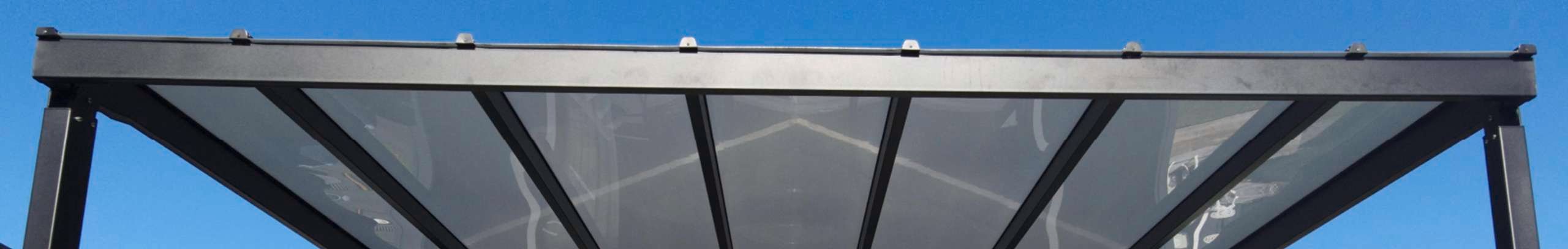 Outdoor structure with sunglaze sheeting providing shelter on an outdoor lounging area