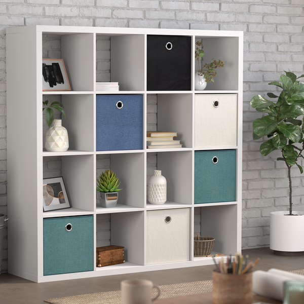 A clever cube storage unit with a plant in a pot and a chair next to it