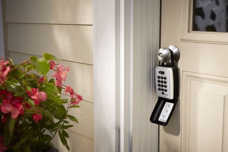 Manual code key lock box attached to door handle