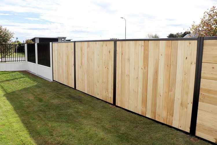 Tall laminated timber fence between neighbouring houses