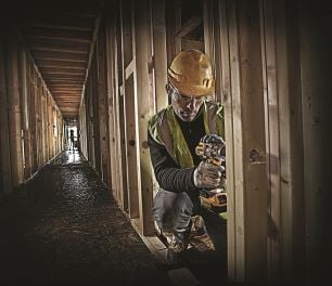 Person nailing timber with nail gun