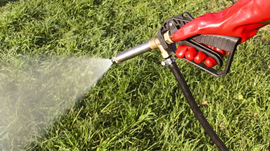 Close up of sprayer attachment being used in a field 