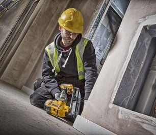 Person nailing timber with nail gun