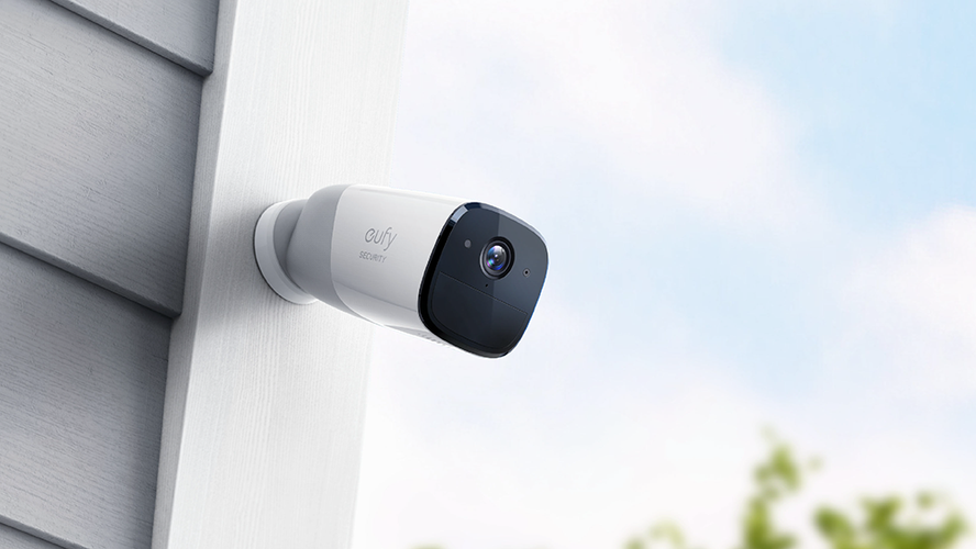 Security camera attached to exterior of house