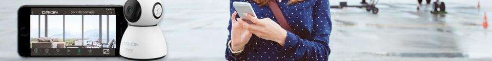 Woman looking at her phone with an Orion camera device positioned front and centre alongside a smartphone screen